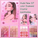 Flat lay of Huda Beauty's 117 Color Diamond Crystal Eyeshadow palette, surrounded by makeup brushes.