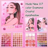 Flat lay of Huda Beauty's 117 Color Diamond Crystal Eyeshadow palette, surrounded by makeup brushes.